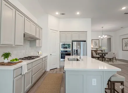 a kitchen with stainless steel appliances a sink a stove and cabinets