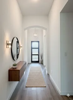 an empty room with mirror and a window