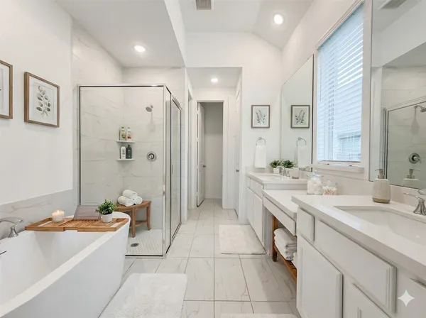 a spacious bathroom with a granite countertop tub sink shower and mirror