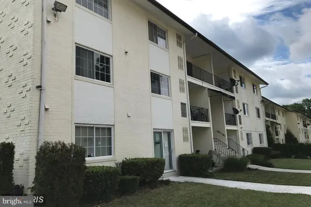 a front view of a building with a garden