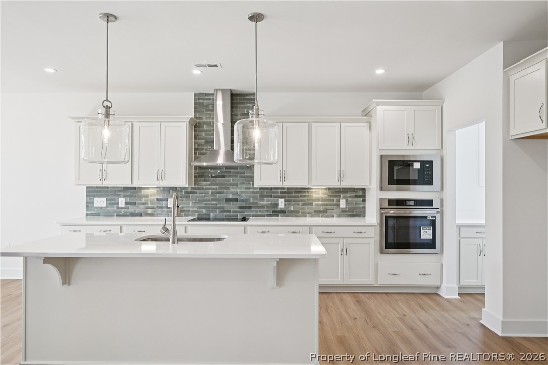 78 Graduate Ct Spring Lake Spring Lake, NC 28390 - Photo 7 of 43 a kitchen with stainless steel appliances granite countertop a sink a stove and a refrigerator