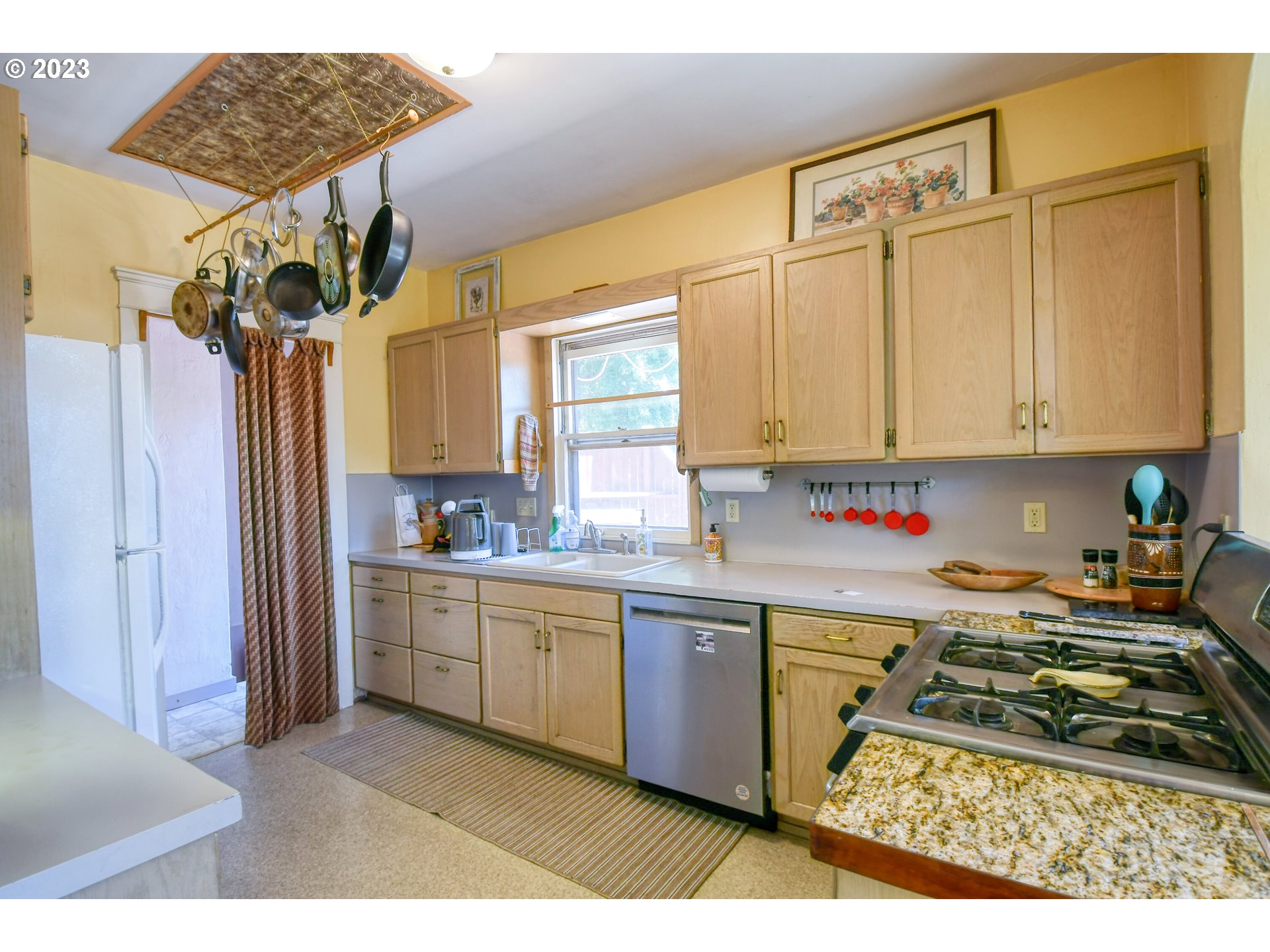 504 Northwest 8th Street Pendleton, OR 97801 - Photo 23 of 48 a kitchen with a sink a stove cabinets and a window