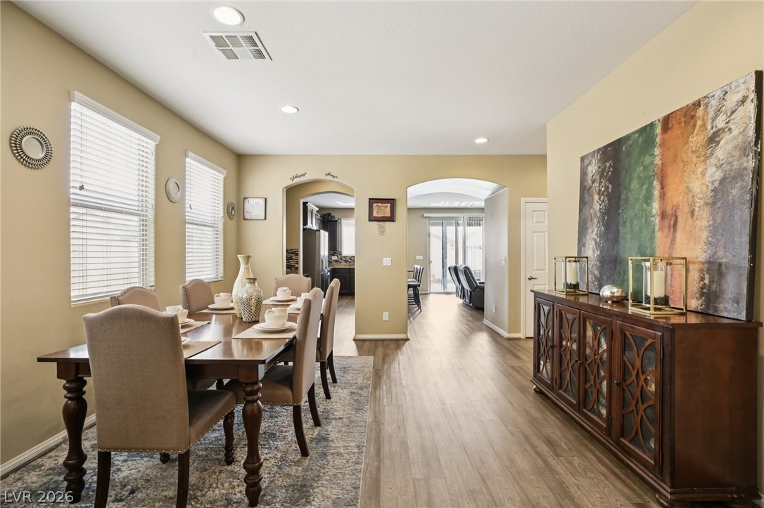 3957 East Carla Ann Road North Las Vegas, NV 89081 - Photo 10 of 35 Dining space featuring arched walkways, wood finished floors, and recessed lighting
