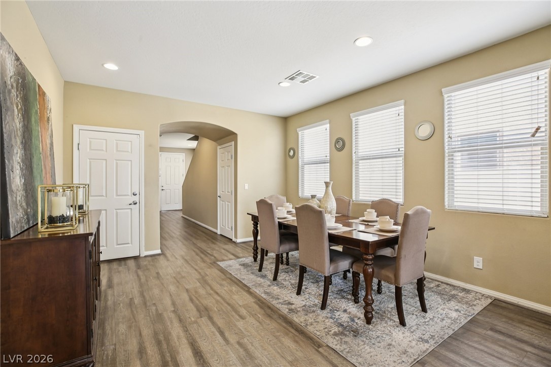 3957 East Carla Ann Road North Las Vegas, NV 89081 - Photo 11 of 35 Dining area featuring arched walkways, light wood-type flooring, and recessed lighting