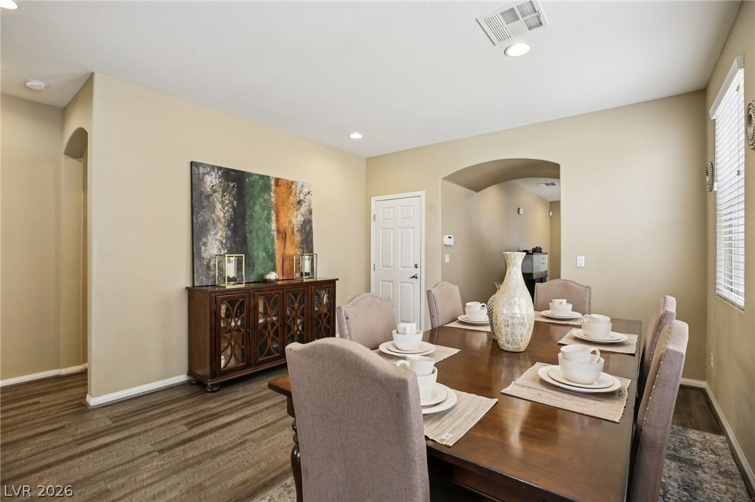 3957 East Carla Ann Road North Las Vegas, NV 89081 - Photo 12 of 35 Dining room with arched walkways, recessed lighting, and dark wood-type flooring