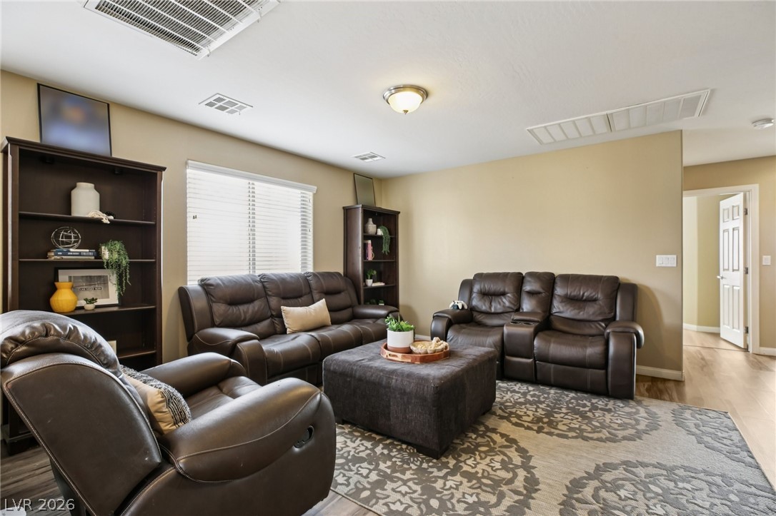 3957 East Carla Ann Road North Las Vegas, NV 89081 - Photo 13 of 35 Living room featuring cooling unit and light wood finished floors