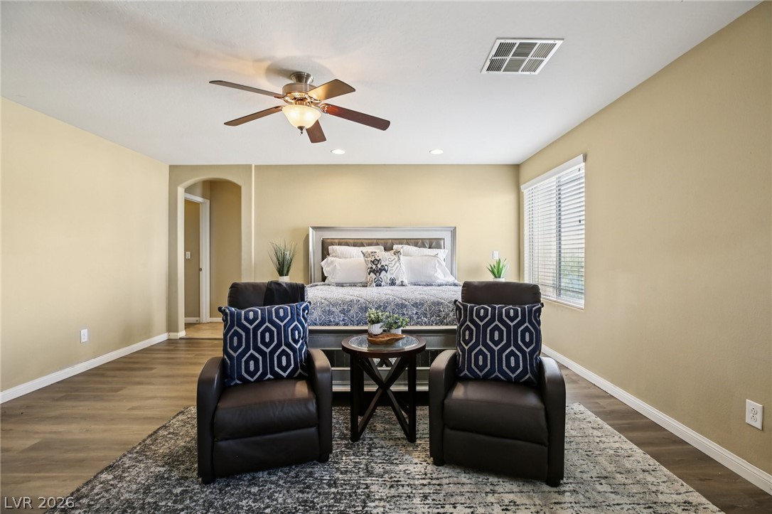 3957 East Carla Ann Road North Las Vegas, NV 89081 - Photo 17 of 35 Bedroom with arched walkways, dark wood finished floors, recessed lighting, and a ceiling fan