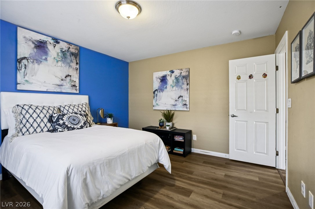 3957 East Carla Ann Road North Las Vegas, NV 89081 - Photo 23 of 35 Bedroom featuring dark wood-style floors and baseboards
