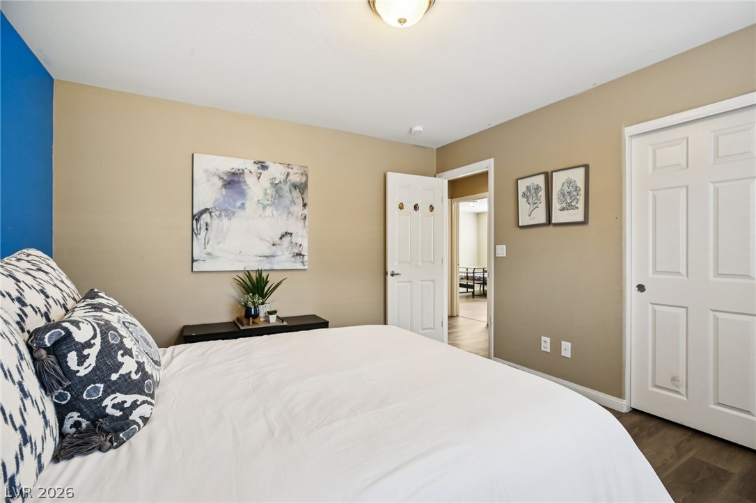 3957 East Carla Ann Road North Las Vegas, NV 89081 - Photo 24 of 35 Bedroom featuring wood finished floors and baseboards