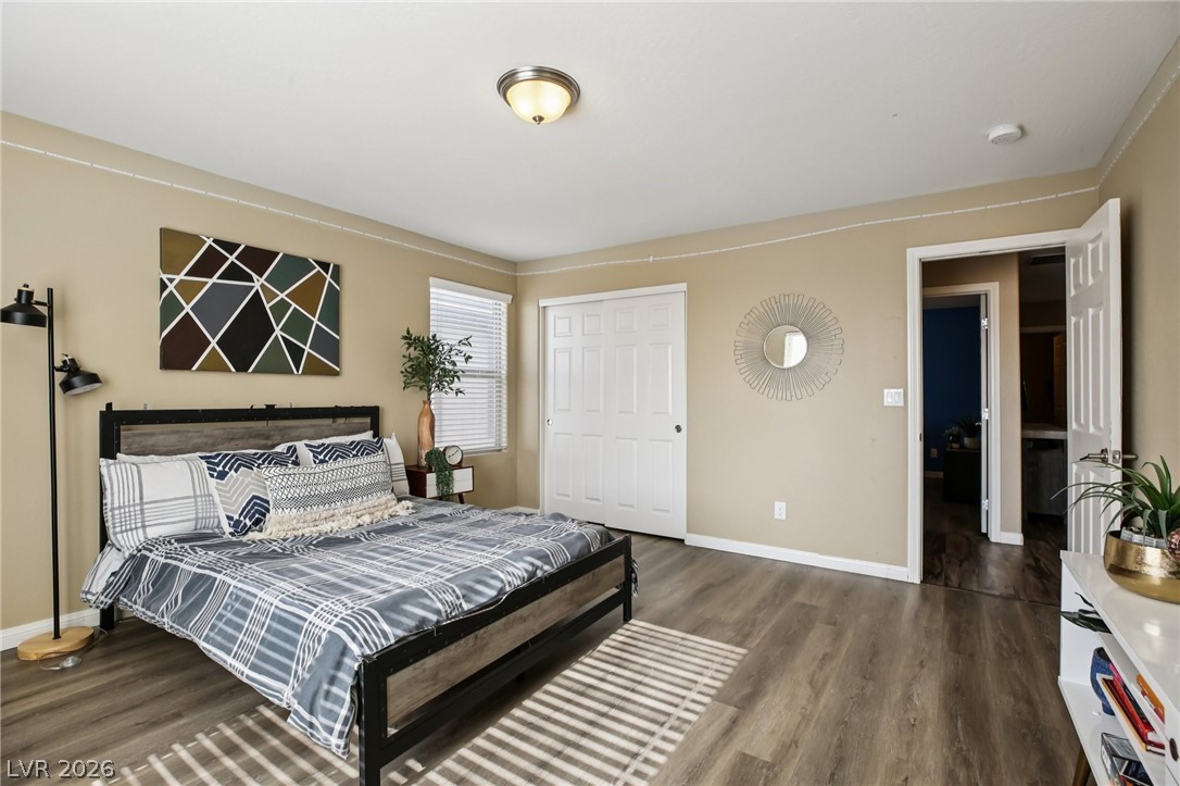 3957 East Carla Ann Road North Las Vegas, NV 89081 - Photo 28 of 35 Bedroom featuring dark wood finished floors and baseboards