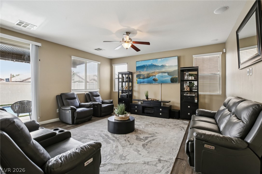3957 East Carla Ann Road North Las Vegas, NV 89081 - Photo 6 of 35 Living area with dark wood-type flooring, a ceiling fan, and plenty of natural light