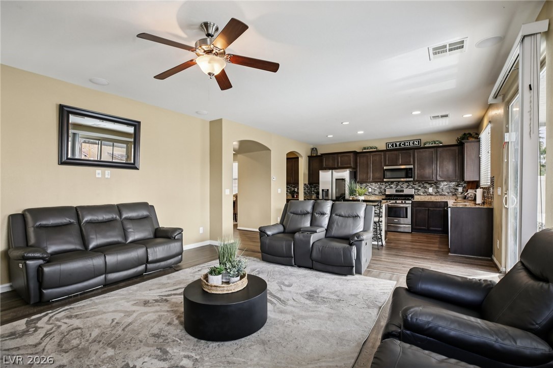 3957 East Carla Ann Road North Las Vegas, NV 89081 - Photo 8 of 35 Living room featuring arched walkways, light wood-style flooring, ceiling fan, and recessed lighting