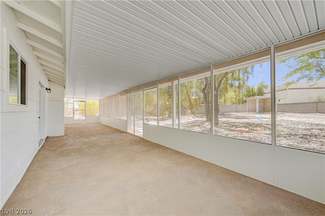 7631 Bermuda Road Las Vegas, NV 89123 - Photo 32 of 64 A spacious sunroom offers tranquil views of the private yard, perfect for relaxation.