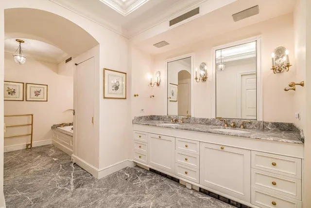 a bathroom with a granite countertop sink a mirror a vanity and a