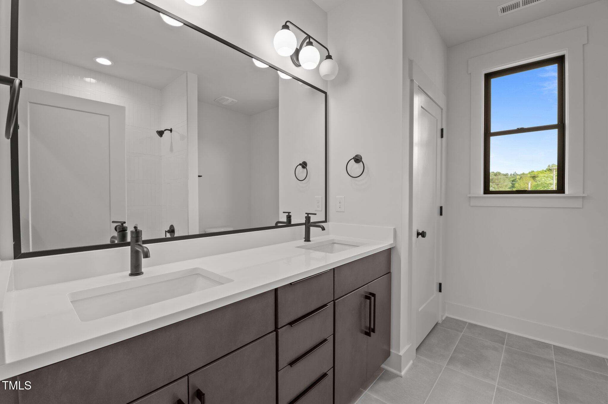200 Broadleaf Lane Louisburg, NC 27549 - Photo 31 of 57 a bathroom with a sink and a mirror