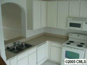 208 Dawn Mist Lane, Unit 208 Fort Mill, SC 29708 - Photo 2 of 6 a kitchen with a sink a stove and cabinets