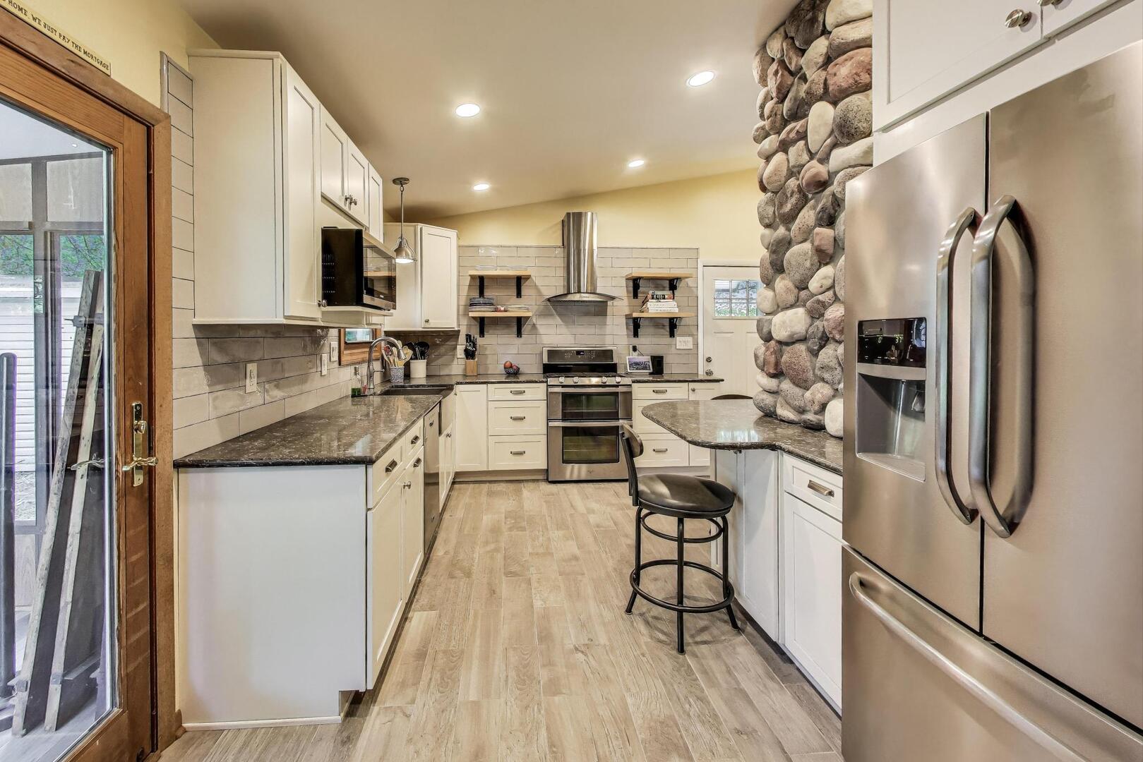 312 Douglas Road Batavia, IL 60510 - Photo 6 of 18 a kitchen with stainless steel appliances granite countertop a refrigerator and a stove top oven