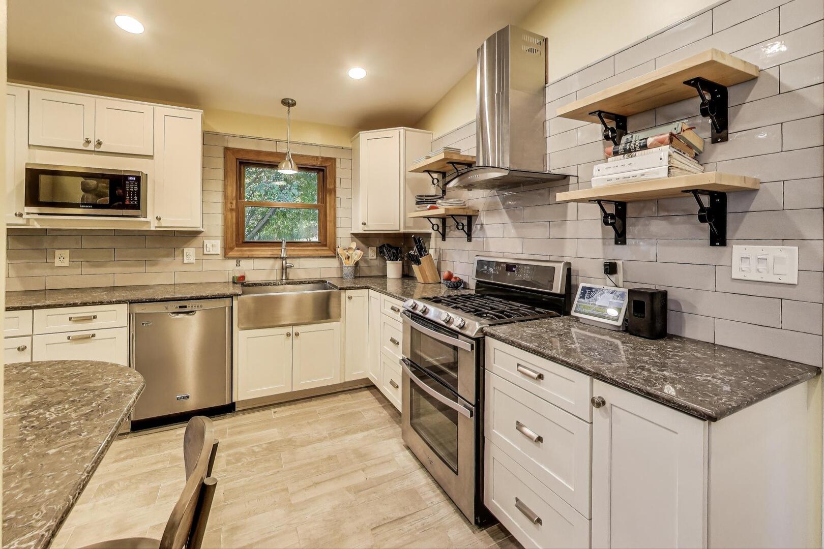 312 Douglas Road Batavia, IL 60510 - Photo 8 of 18 a kitchen with stainless steel appliances granite countertop a sink stove and refrigerator