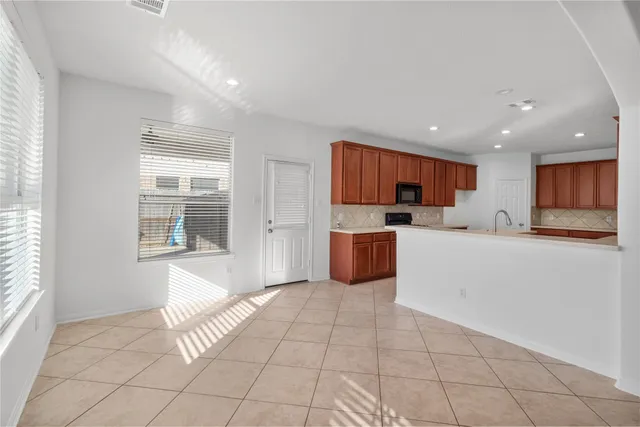 a kitchen with stainless steel appliances a refrigerator sink and cabinets