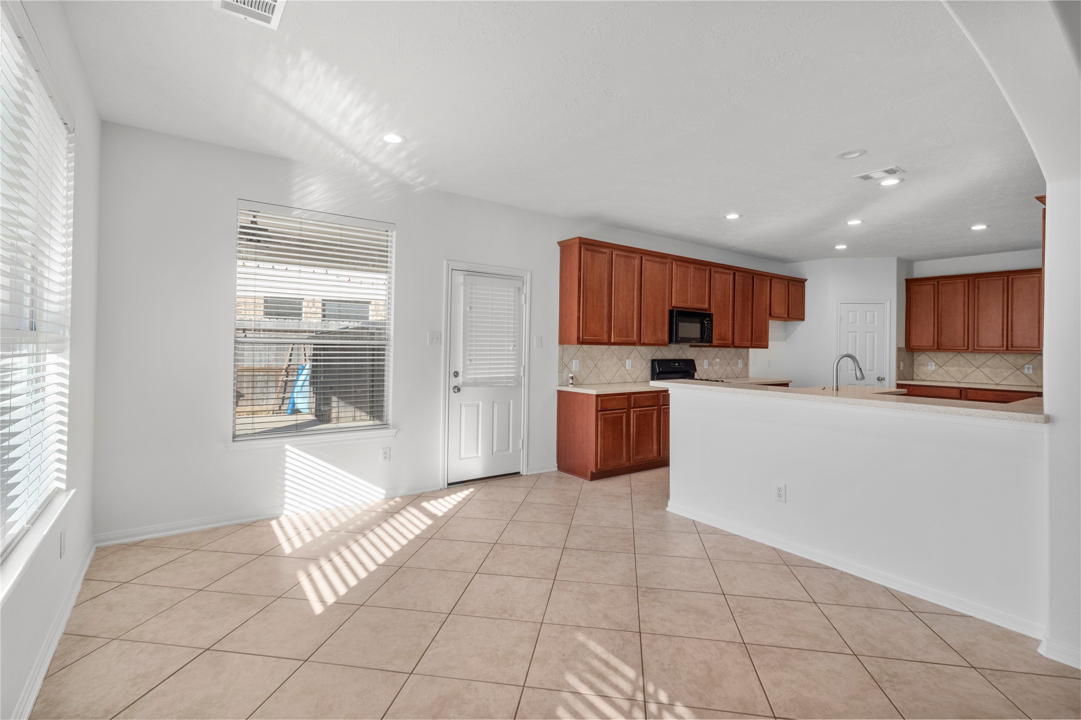 4004 Beacon Pointe Lane Dickinson, TX 77539 - Photo 12 of 28 a kitchen with stainless steel appliances a refrigerator sink and cabinets