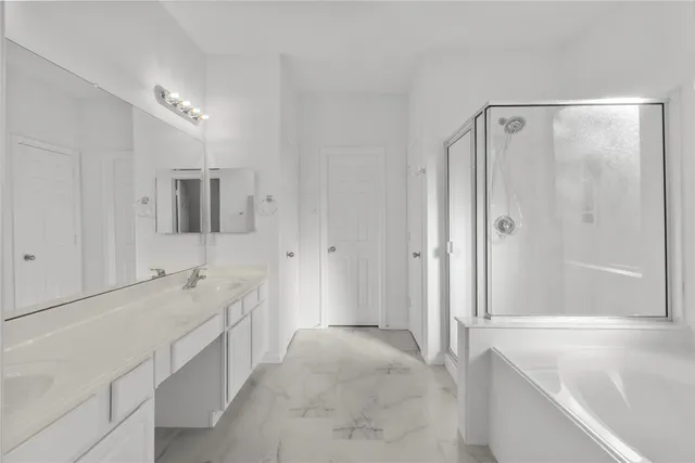a spacious bathroom with a bathtub shower and sink