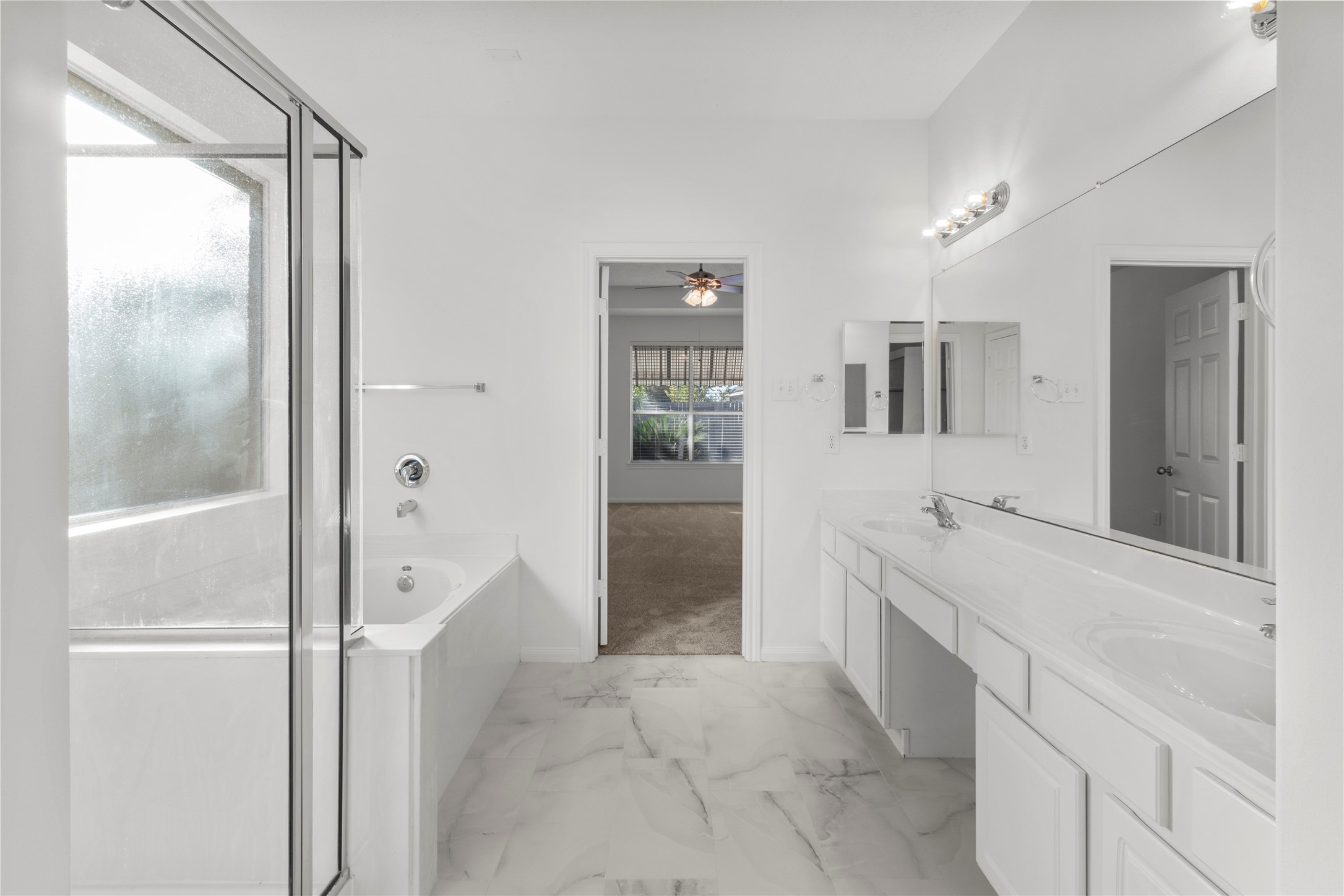 4004 Beacon Pointe Lane Dickinson, TX 77539 - Photo 18 of 28 a bathroom with a granite countertop sink a mirror a bathtub and shower