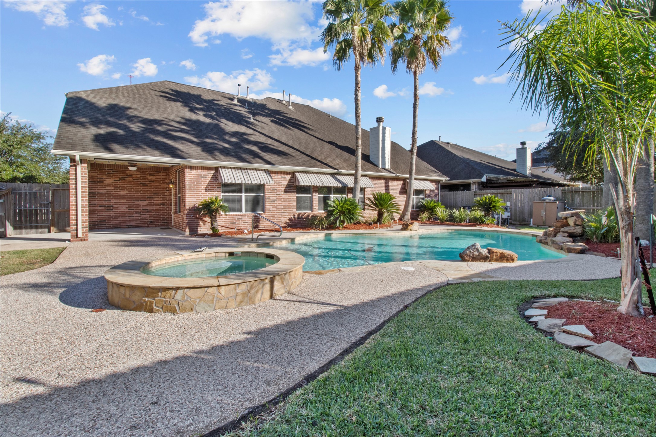 4004 Beacon Pointe Lane Dickinson, TX 77539 - Photo 2 of 28 a view of a house with swimming pool and a garden
