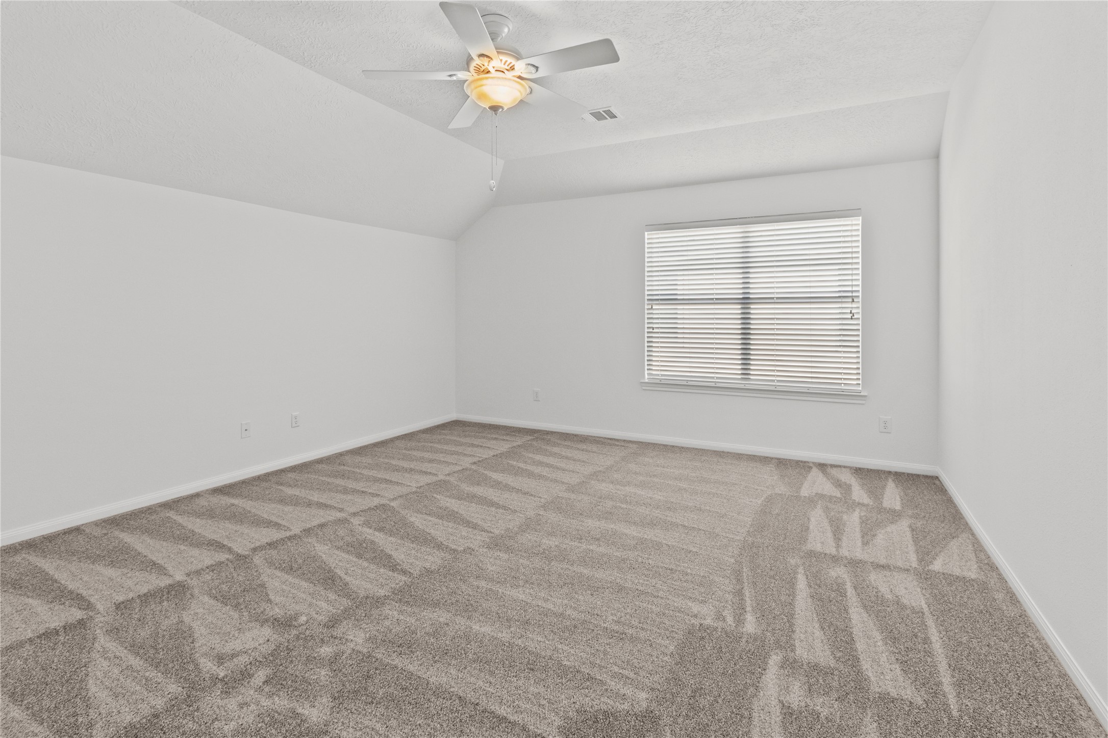 4004 Beacon Pointe Lane Dickinson, TX 77539 - Photo 22 of 28 an empty room with a chandelier fan and windows