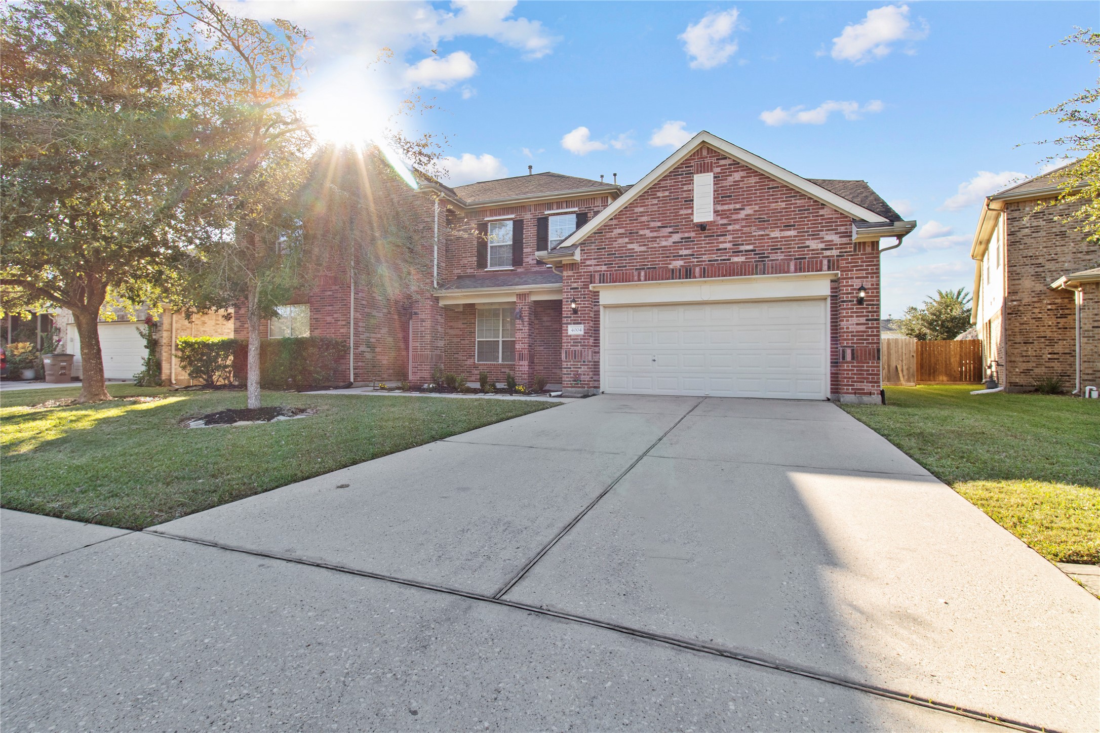 4004 Beacon Pointe Lane Dickinson, TX 77539 - Photo 3 of 28 a front view of a house with a yard and garage