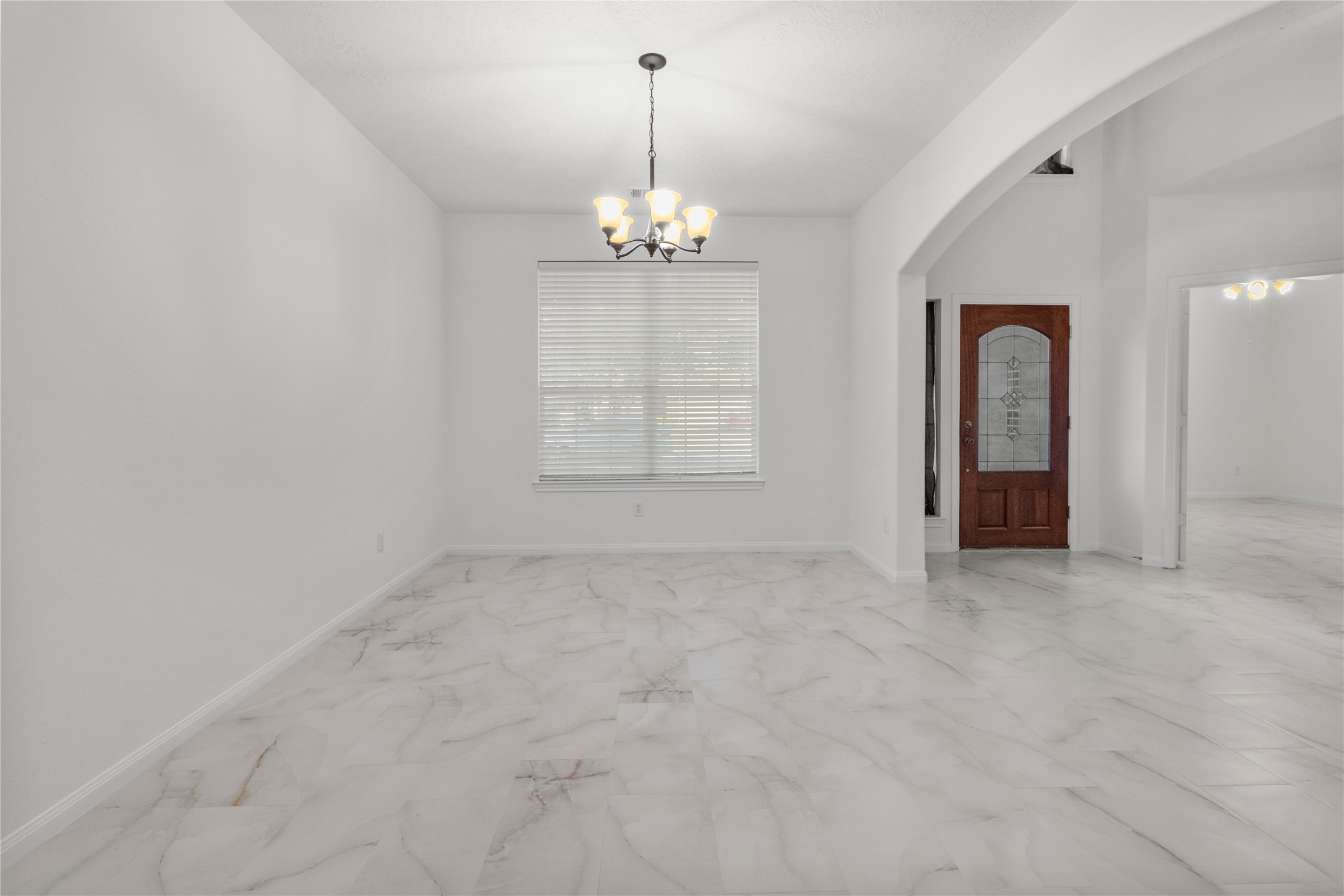 4004 Beacon Pointe Lane Dickinson, TX 77539 - Photo 6 of 28 en empty room with windows and chandelier