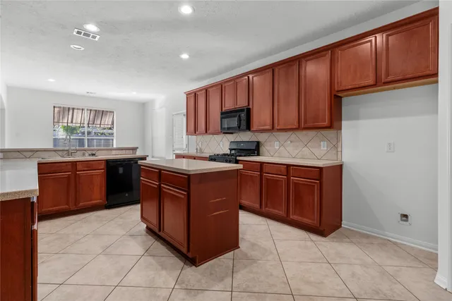a kitchen with stainless steel appliances granite countertop a stove a sink dishwasher and a refrigerator