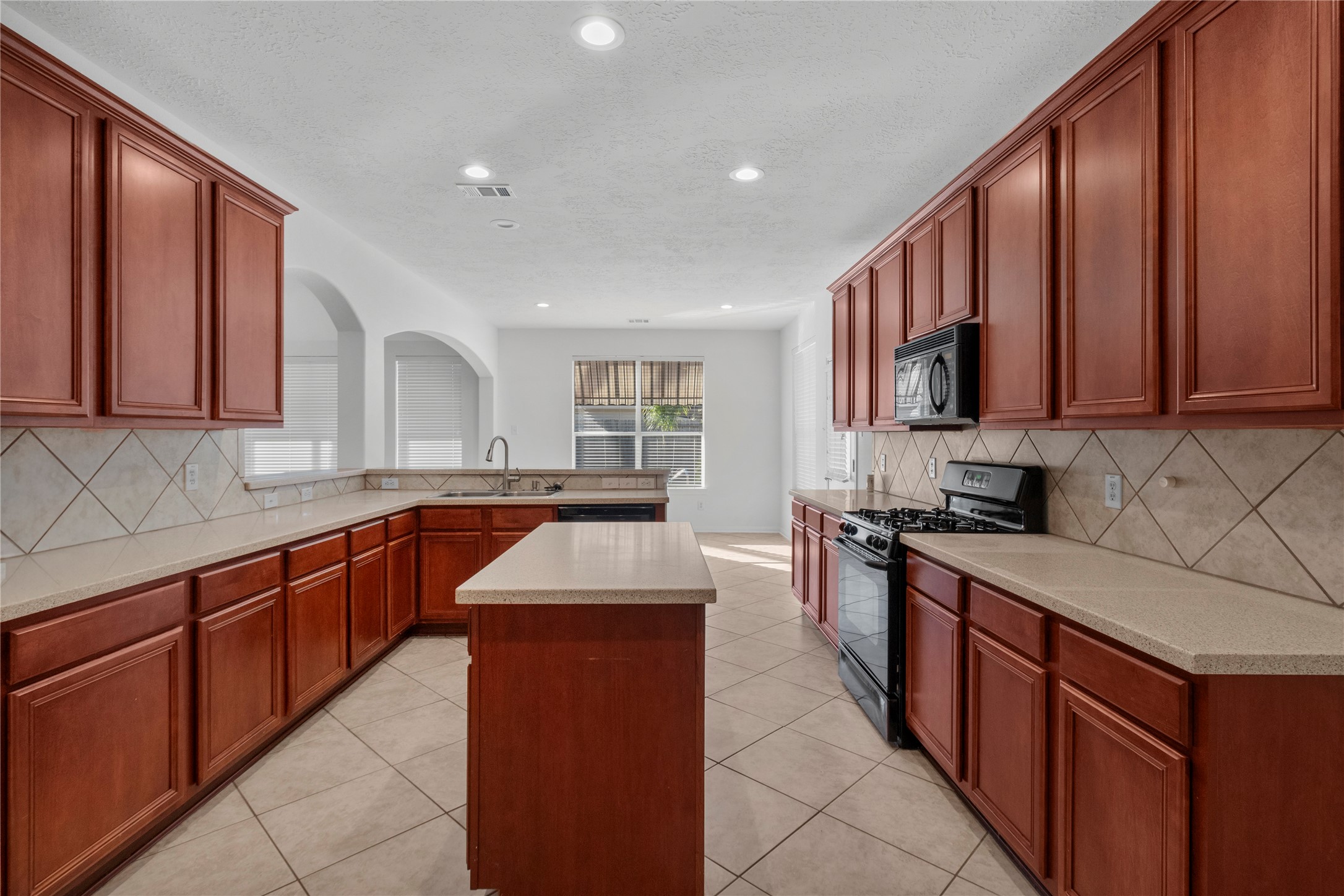 4004 Beacon Pointe Lane Dickinson, TX 77539 - Photo 9 of 28 a kitchen with stainless steel appliances granite countertop wooden cabinets a sink and dishwasher a stove top oven with wooden floor