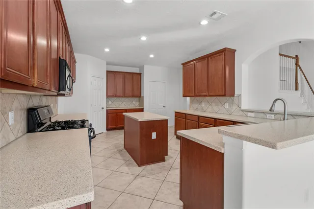 a kitchen with stainless steel appliances granite countertop a sink counter space and cabinets