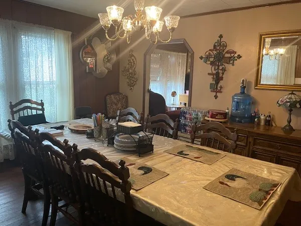 a kitchen with a table chairs and chandelier