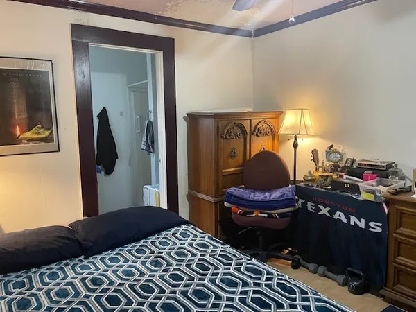 a bedroom with a bed and a mirror
