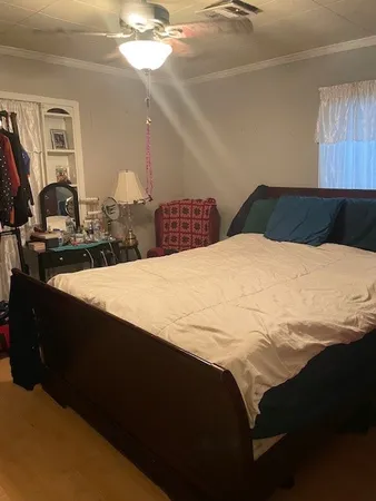 a bedroom with a bed and a chandelier