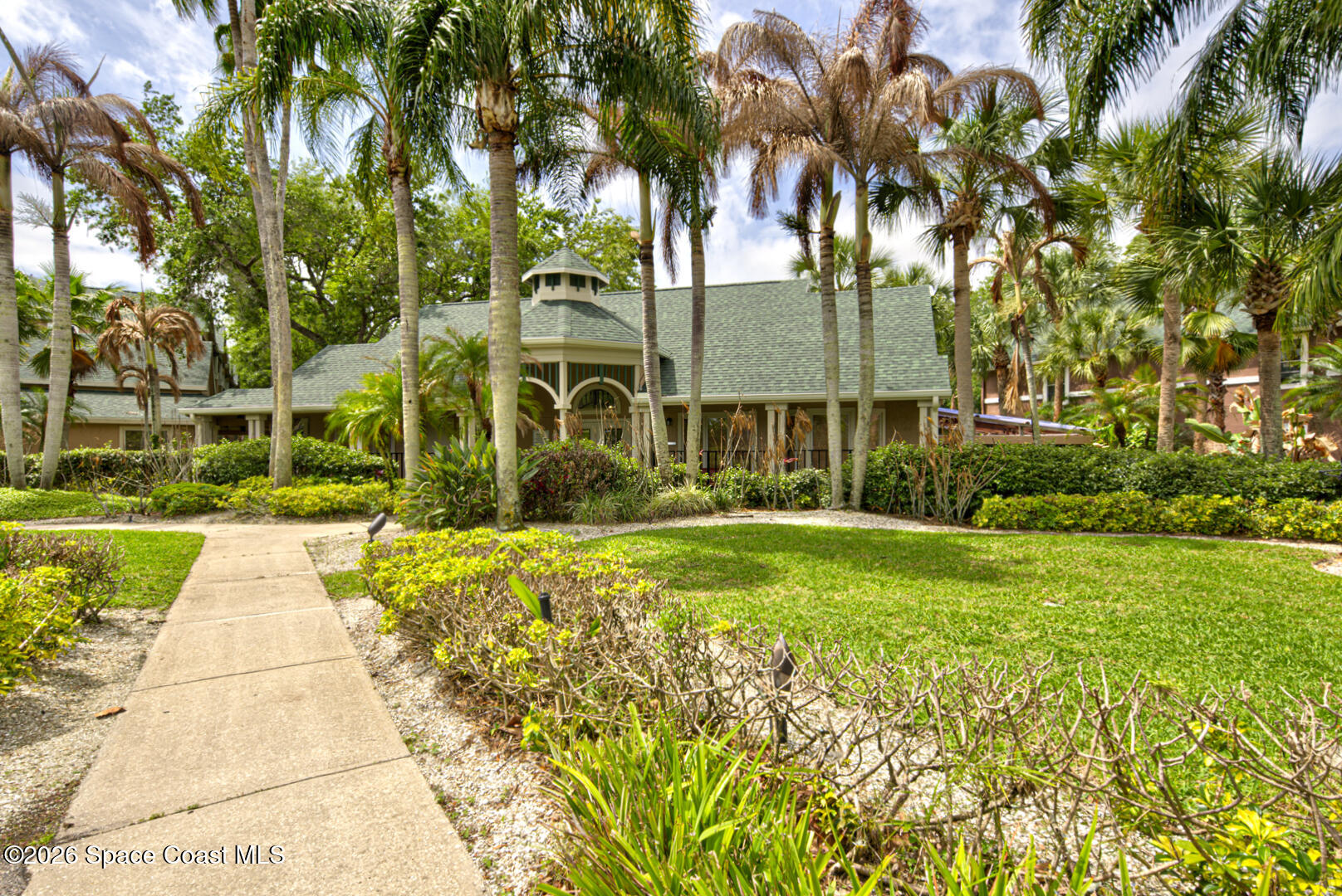 7667 North Wickham Road, Unit 1416 Melbourne, FL 32940 - Photo 34 of 41 a front view of a house with garden