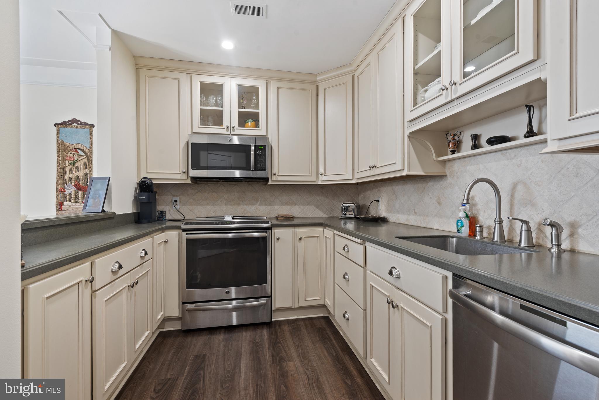 100 Harborview Drive, Unit 612 Baltimore, MD 21230 - Photo 15 of 49 a kitchen with stainless steel appliances granite countertop a stove and white cabinets