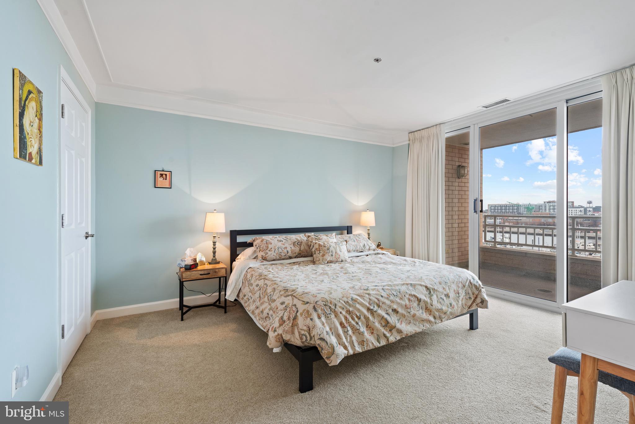 100 Harborview Drive, Unit 612 Baltimore, MD 21230 - Photo 18 of 49 a bedroom with a bed and a night stand