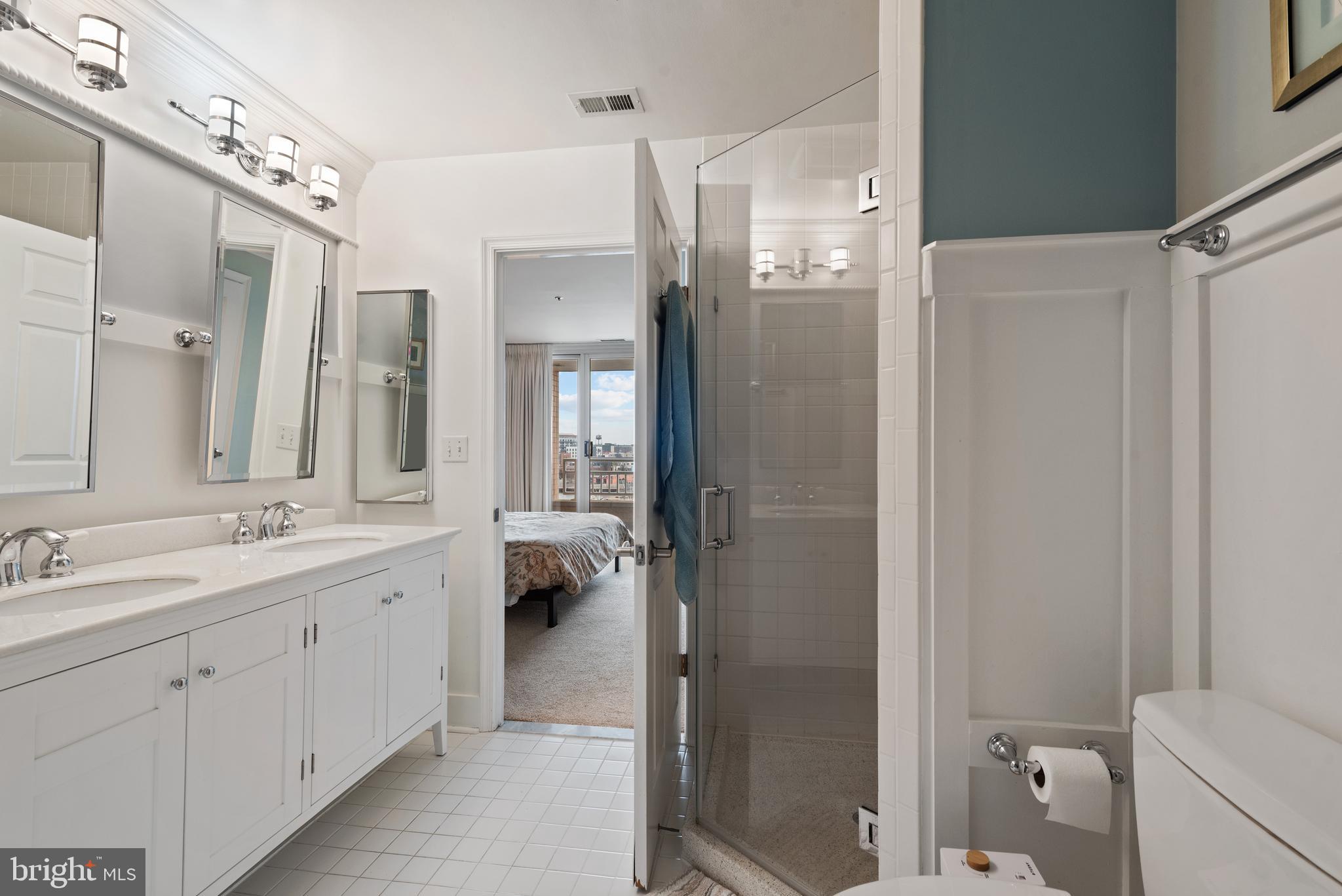 100 Harborview Drive, Unit 612 Baltimore, MD 21230 - Photo 23 of 49 a spacious bathroom with a double vanity sink a toilet a large mirror and shower