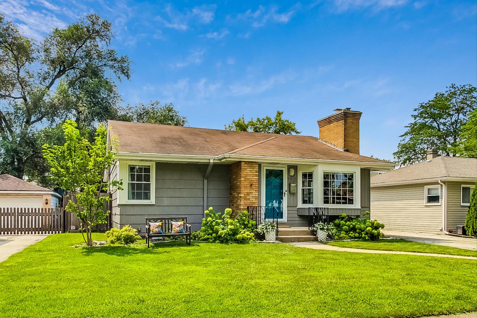 792 Spring Road Elmhurst, IL 60126 - Photo 1 of 26 a front view of a house with a yard