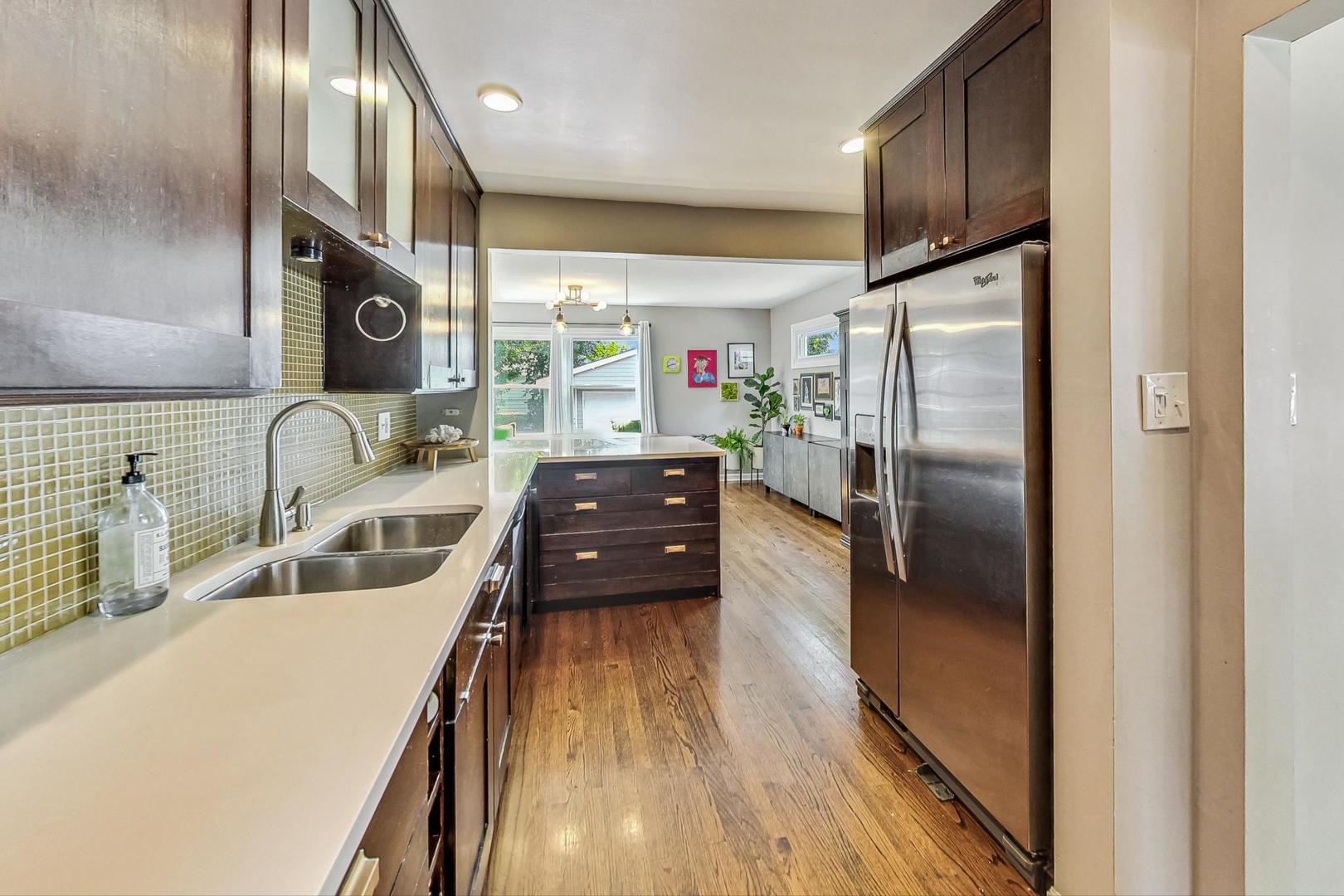 792 Spring Road Elmhurst, IL 60126 - Photo 6 of 26 a kitchen with stainless steel appliances a refrigerator a sink a stove and white cabinets