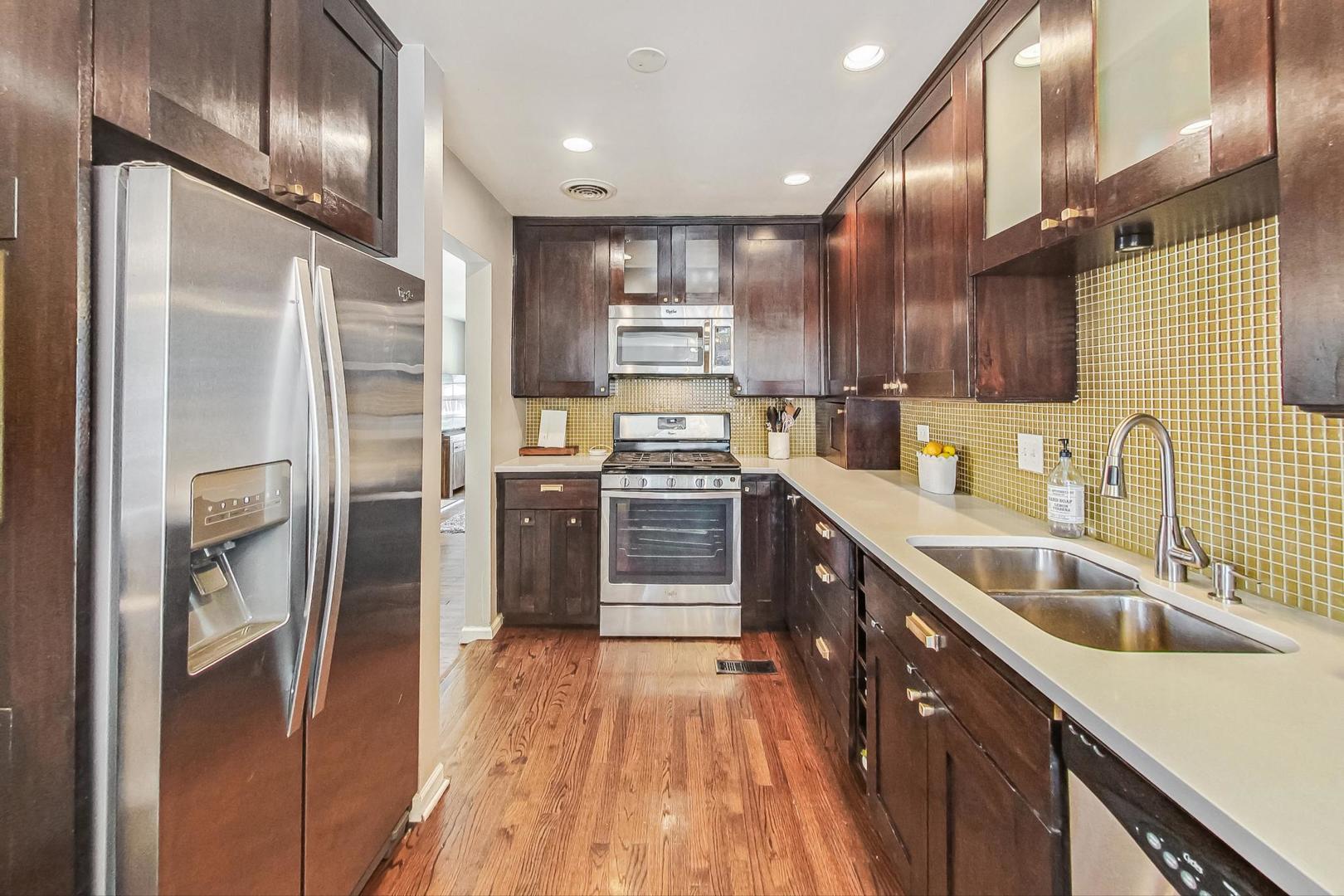 792 Spring Road Elmhurst, IL 60126 - Photo 7 of 26 a kitchen with stainless steel appliances granite countertop a refrigerator and a sink