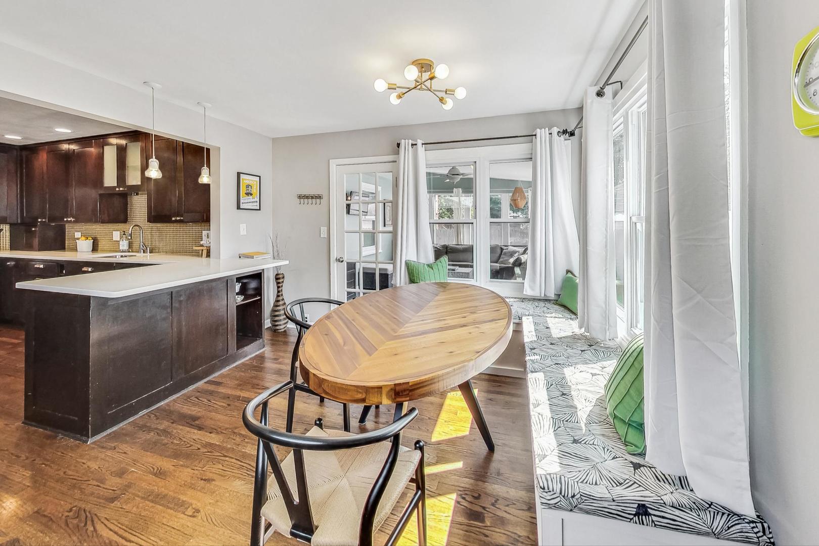 792 Spring Road Elmhurst, IL 60126 - Photo 9 of 26 a view of a dining room with furniture window and wooden floor