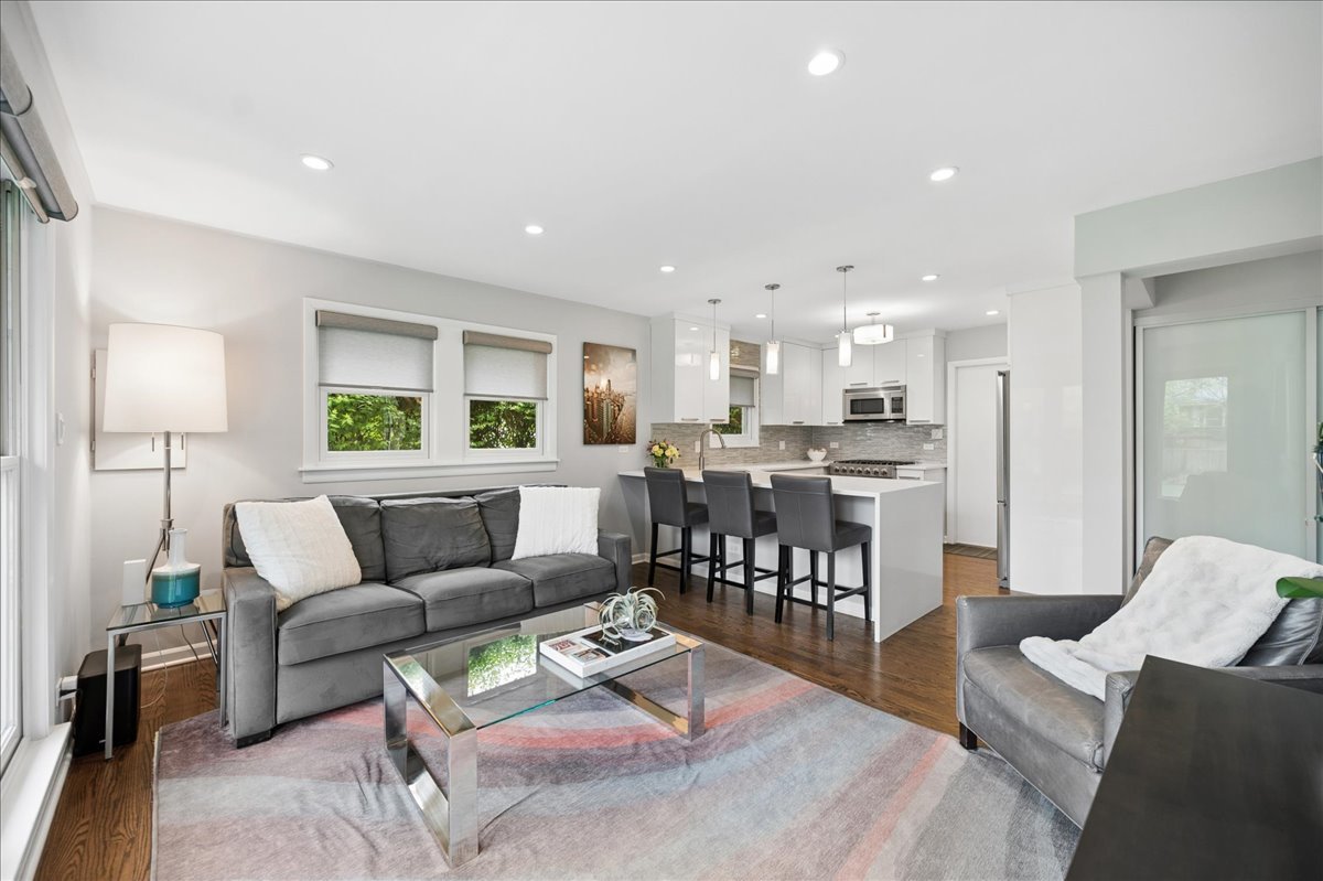912 Hunter Road Wilmette, IL 60091 - Photo 11 of 38 a living room with furniture and a dining table with kitchen view
