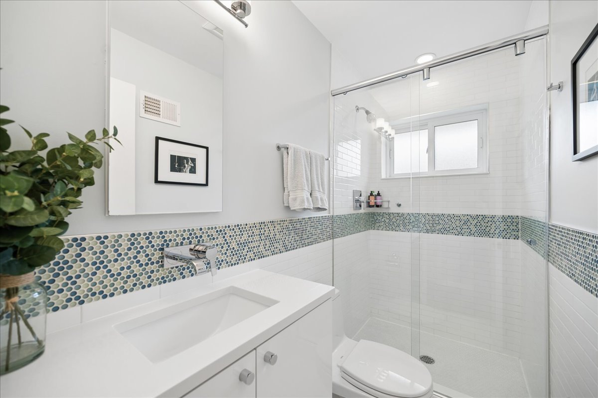 912 Hunter Road Wilmette, IL 60091 - Photo 24 of 38 a bathroom with a bathtub shower sink vanity and toilet