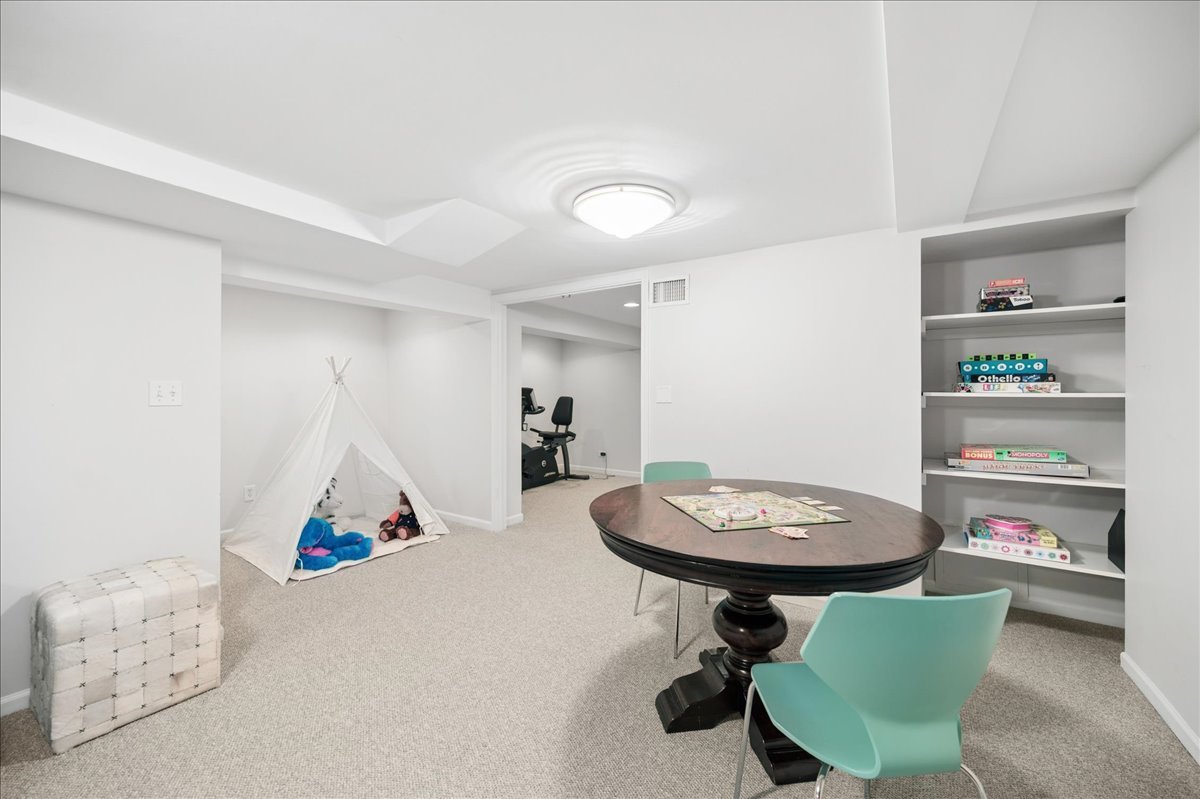 912 Hunter Road Wilmette, IL 60091 - Photo 28 of 38 a room with a table chairs and a chandelier