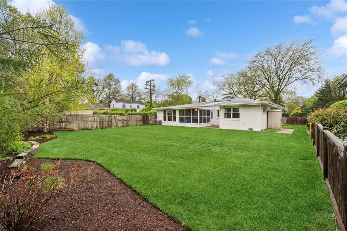 912 Hunter Road Wilmette, IL 60091 - Photo 34 of 38 a front view of a house with a garden