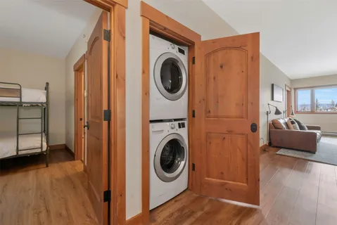 a view of a hallway with entryway and stairs