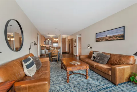 a living room with furniture and a mirror